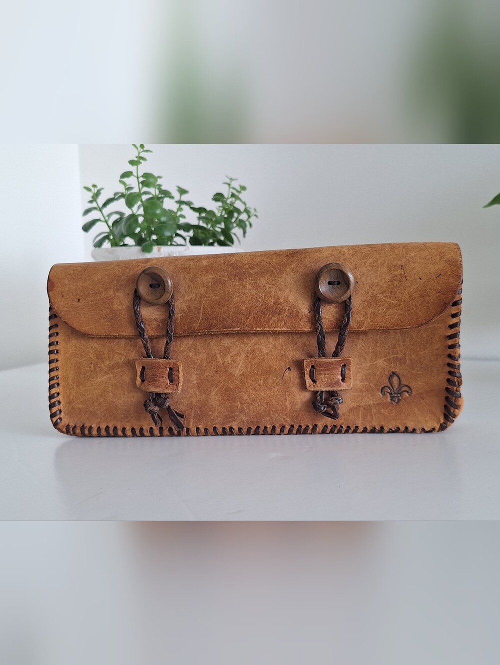 Antique leather case with a fleur-de-lis